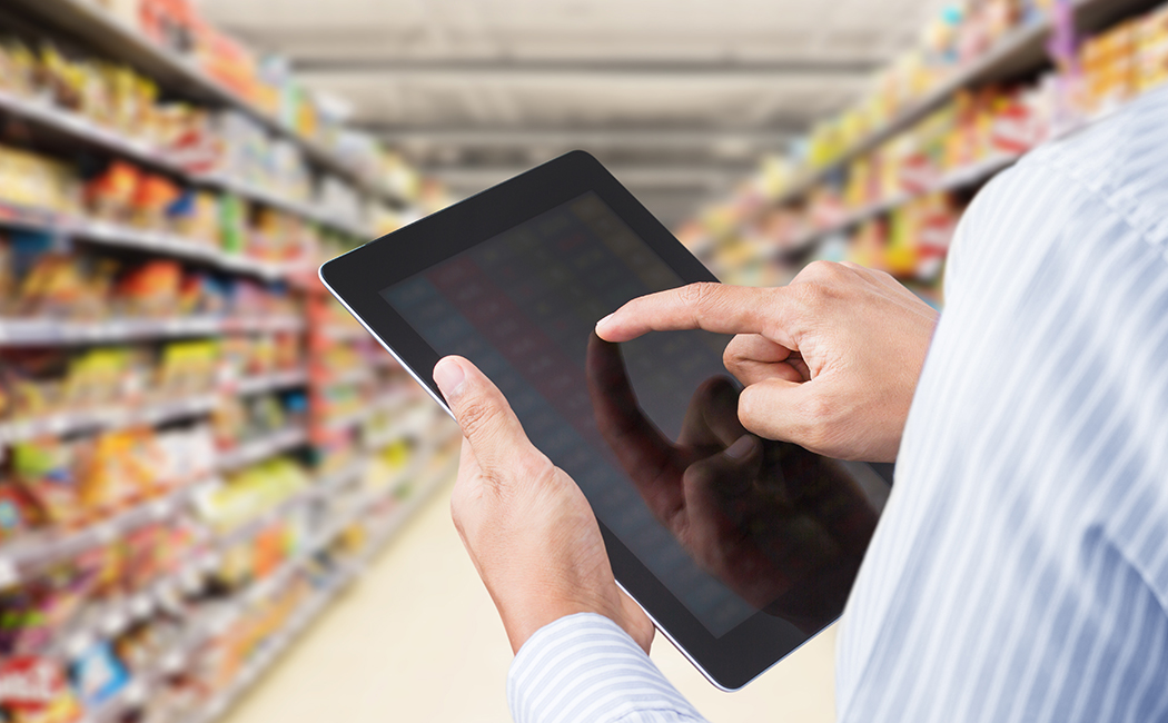 person with ipad in grocery store