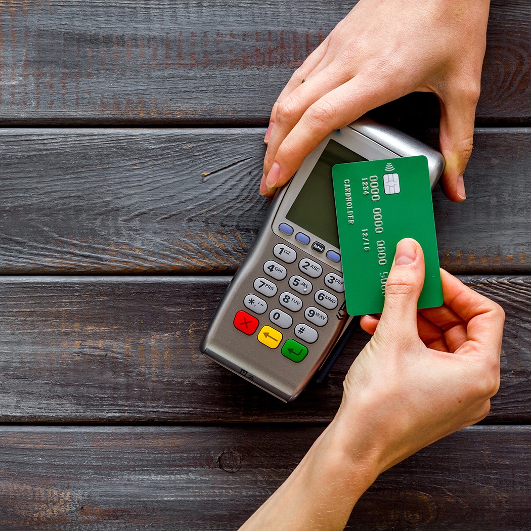 hands with credit card machine